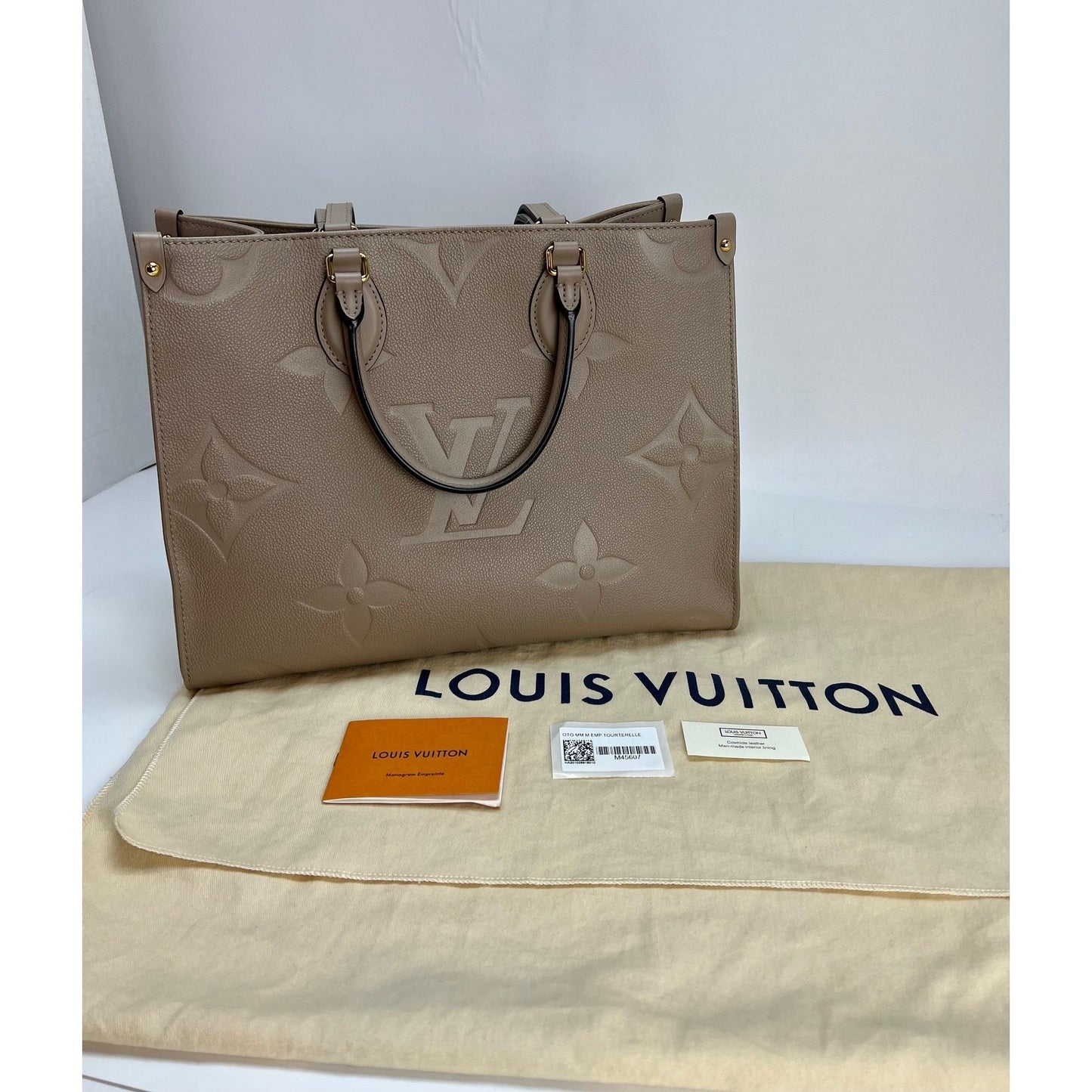 OnTheGo MM Tote Bag - Luxury Monogram Empreinte Leather Beige